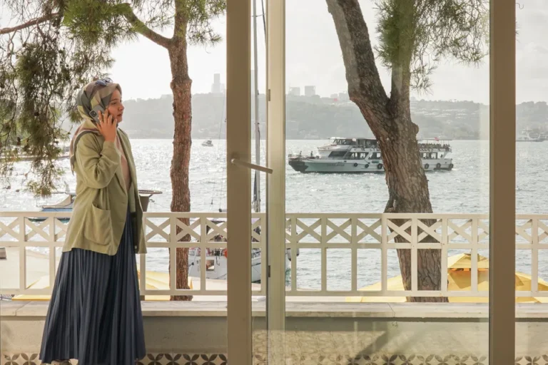 A visitor using a phone beside the Bosphorus in Istanbul