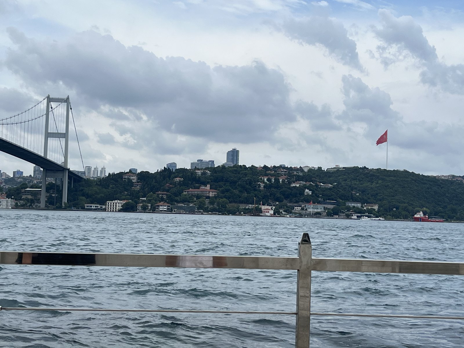 Bridge tower and a Turkish flag on the opposite hillside above the Bosphorus