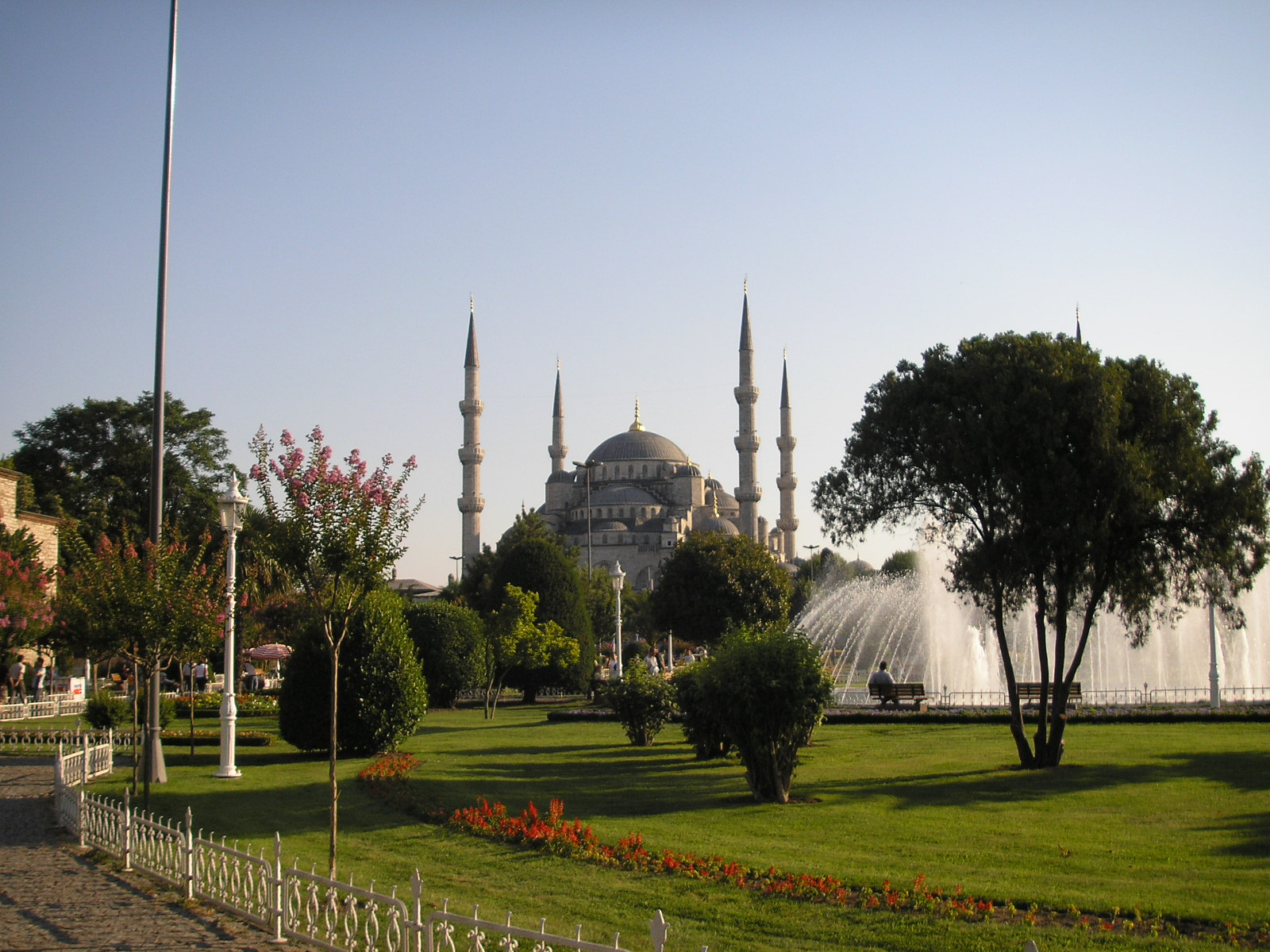 The six-minaret Blue Mosque rising over trees and a fountain in a park in Sultanahmet