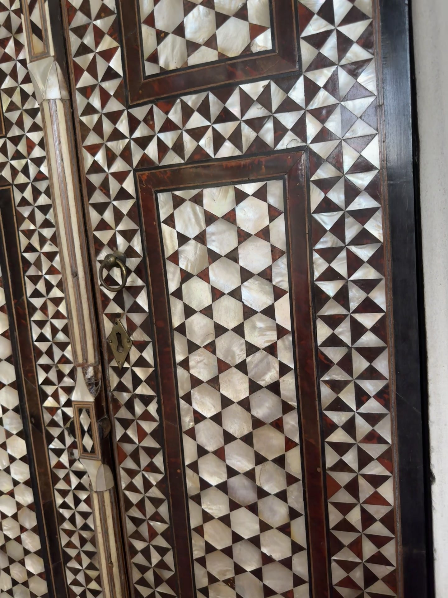 Door inlaid with white mother-of-pearl triangles and stars in dark wood frames in the Topkapı Harem