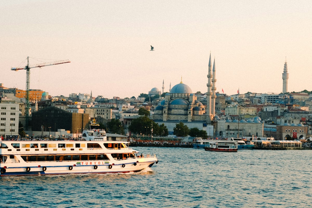 A passenger ferry crossing the Bosphorus in Istanbul at sunset