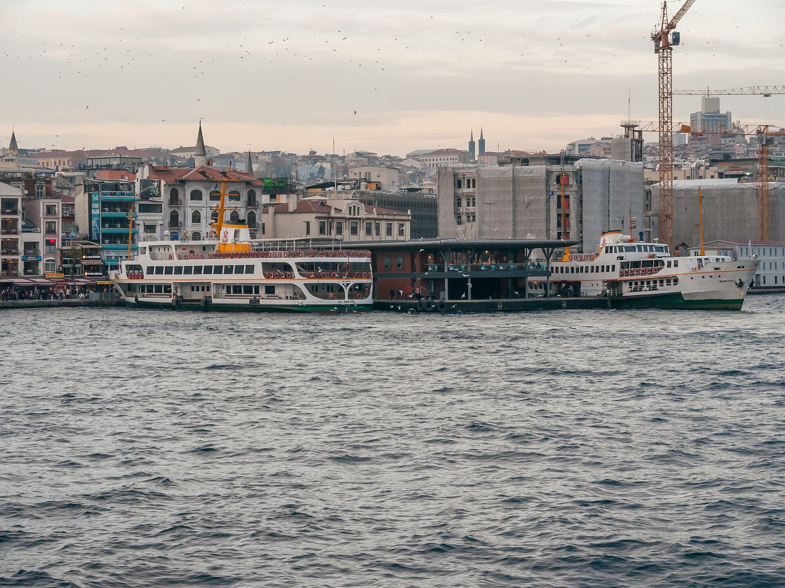 Şehir Hatları ferries at the Karaköy pier with the Galata skyline behind