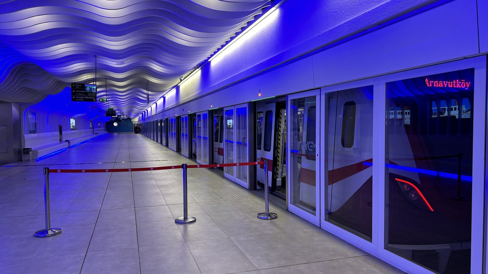 Blue-lit platform with screen doors on the M11 metro line in Istanbul