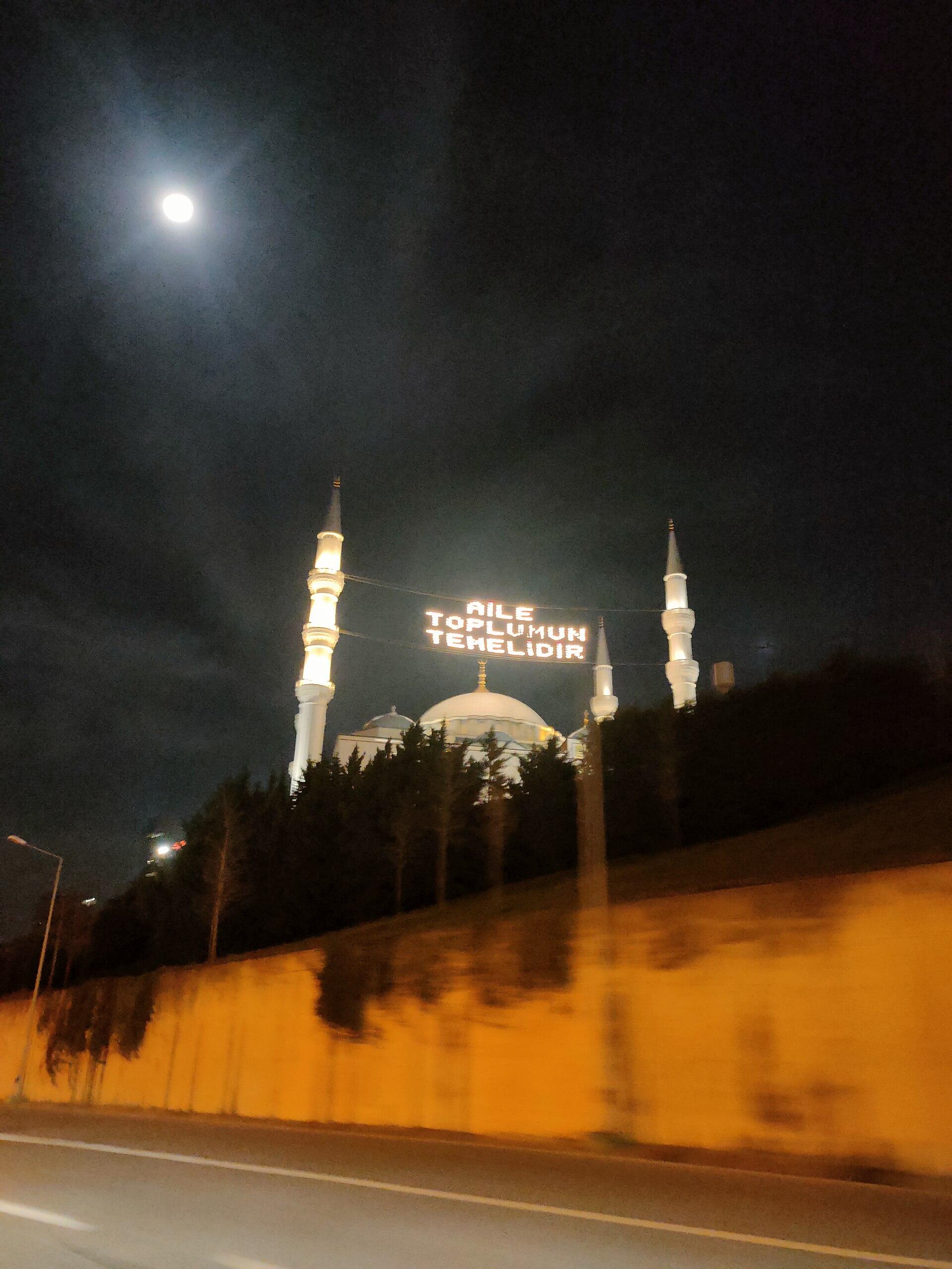 Mahya lights strung between the minarets of a mosque at night in Istanbul