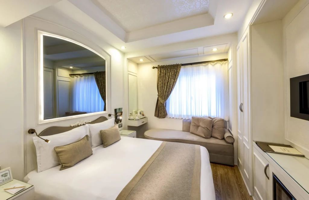 Yasmak Sultan family room with a double bed, sofa and light-coloured furnishings